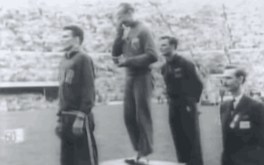 An emotional Josy Barthel atop the podium at the Helsinki Olympics on 26 July 1952, with then Crown Prince Jean in the foreground. Olympic Channel screenshot