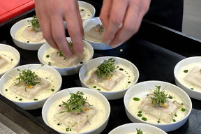 Preparing sea bass confit in olive oil, served with cockles and fresh wasabi root. Photo: Céline Coubray