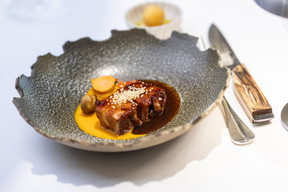 Barbecued candied pork belly, carrots, chestnuts and tomato chimichurri. Photo: Guy Wolff/Maison Moderne