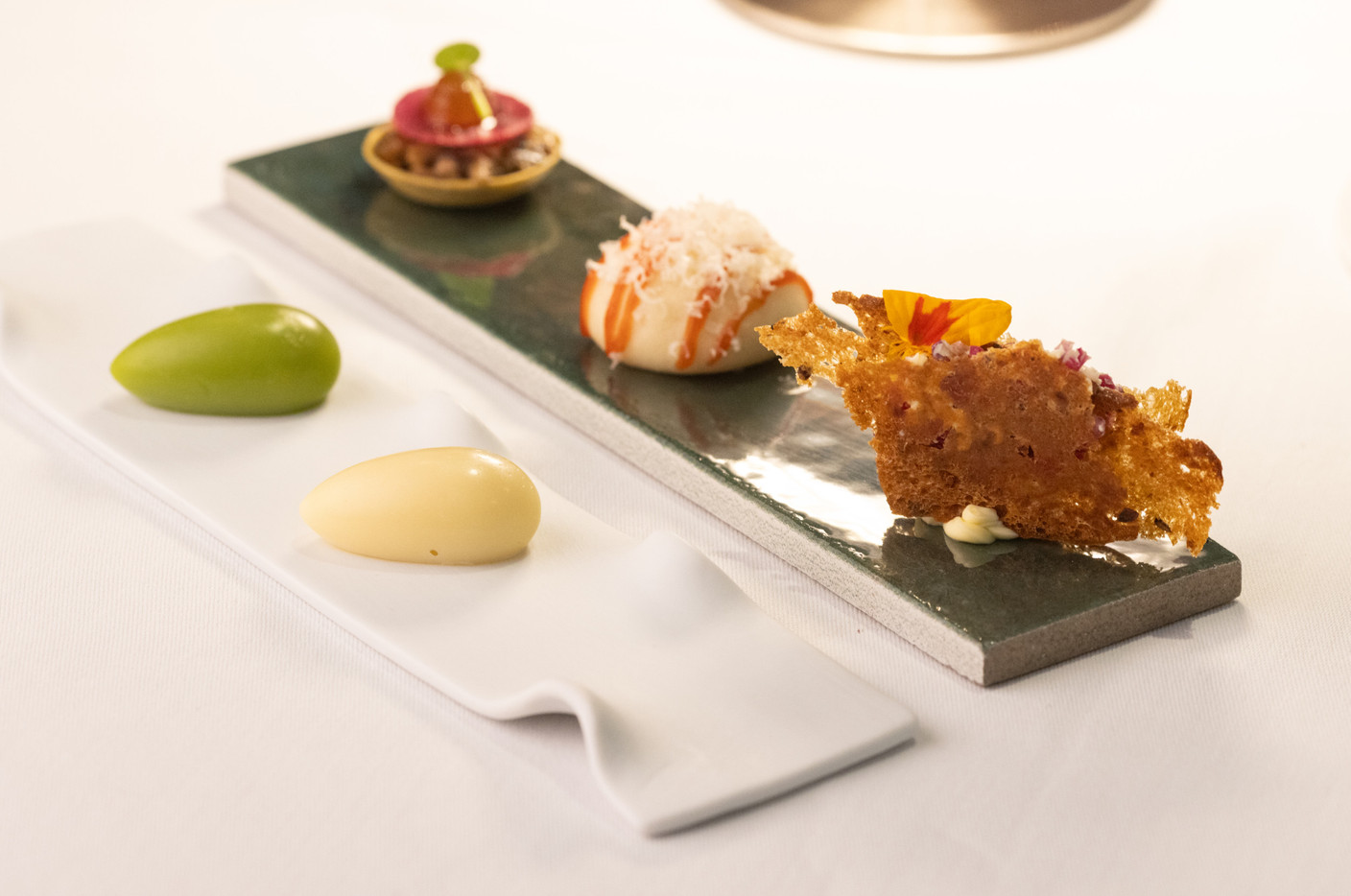 Tartelette with rosemary and champigons, petit bao with Rochehaut tomme and millefeuilles of radish and butter. Photo: Guy Wolff/Maison Moderne