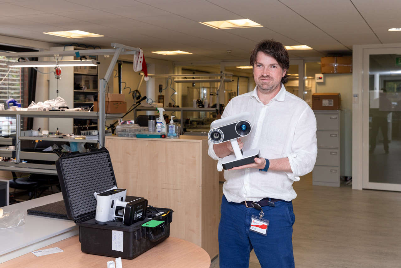 Artyom Yukhin, CEO and founder of Artec 3D, holding one of his company's scanners. Photo: Romain Gamba