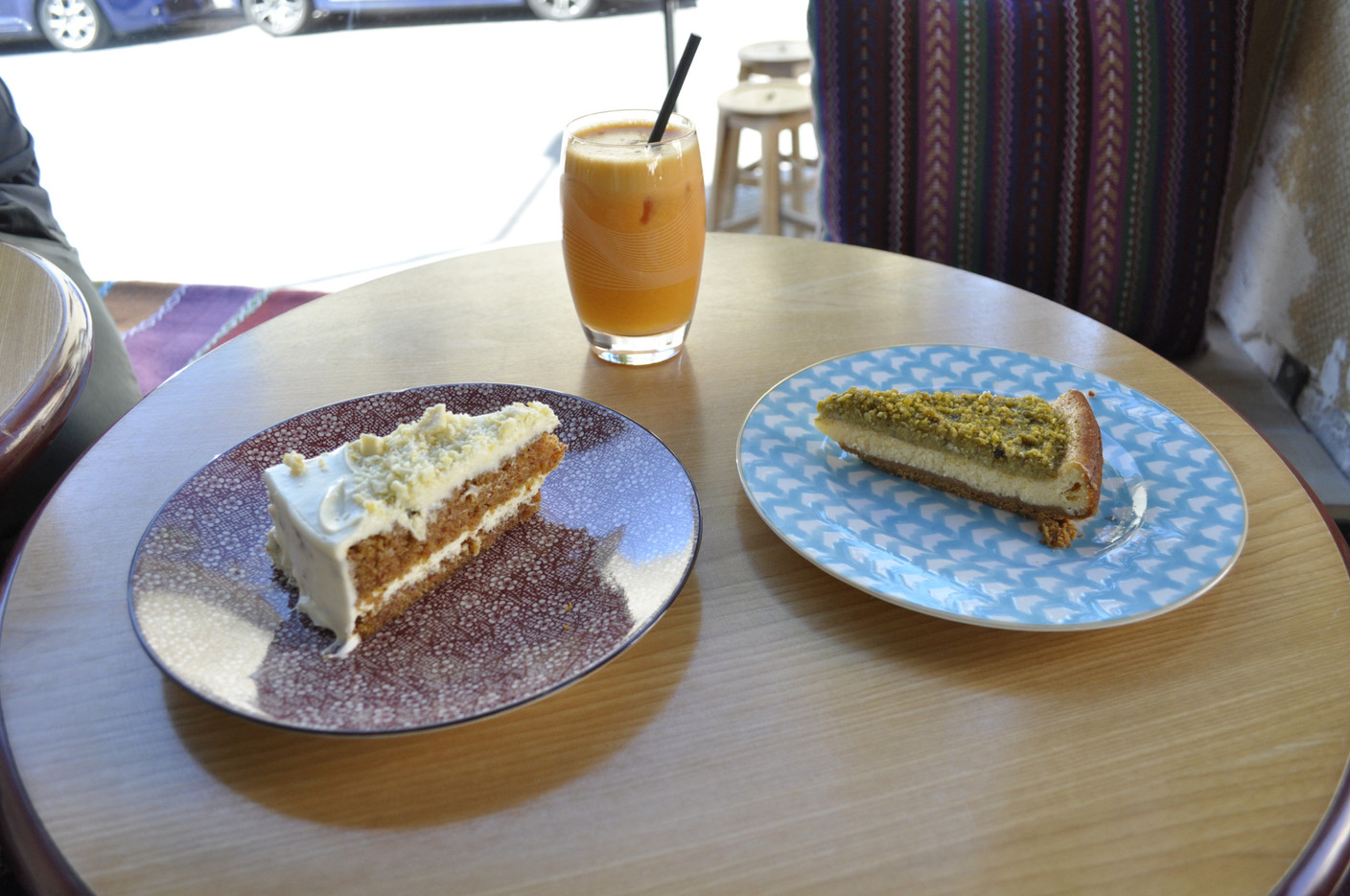 À gauche, le célèbre carrot cake de Konrad, avec un cheesecake pistache et un jus de fruits frais pomme-carotte-gingembre.   (Photo: Maison Moderne)