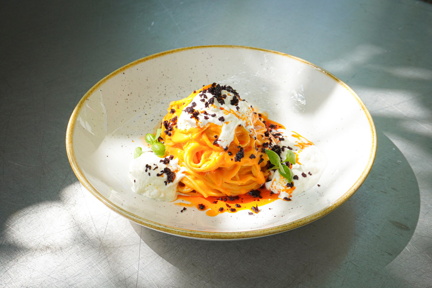 Craft Tagliolini with datterini and burrata cream, Kalamata olive powder, tomato oil and baby basil. Photo: Service Marketing - Groupe Bon Appétit