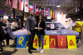 Posing with a plate of sarma (stuffed cabbage rolls) and polenta from the Romanian stand, Alexandrina, an employee of PwC, a sponsor of the Bazar, says that the Bazar is a very good way to socialise, meet people and eat good food. Matic Zorman / Maison Moderne