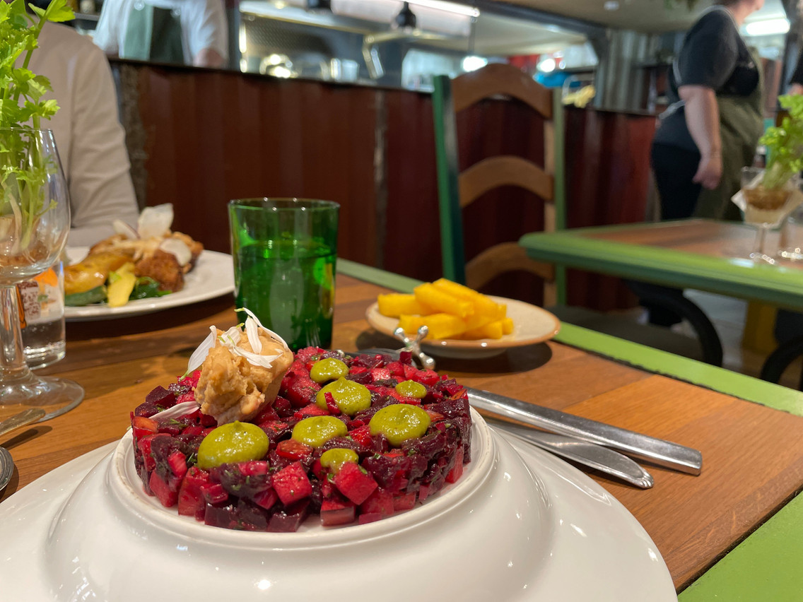 Pictured is a dish prepared using rescued food: beetroot tartar, leek cream, celery mousseline, daisy flower and polenta fries. Photo: Provided by Benu Sloow