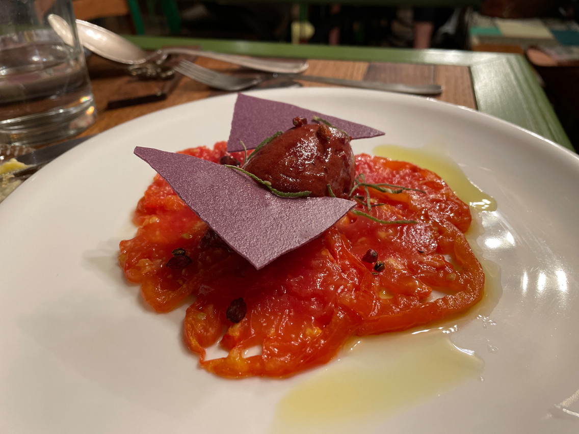 An example of a dessert at Benu Sloow: candied tomato, plum ice cream, redcurrant, wild herbs. Photo: Provided by Benu Sloow