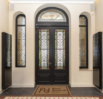 Period stained-glass windows and ironwork: one of the interior spaces of the Royal Roosevelt House following renovation. (Photo: BGL BNP Paribas)