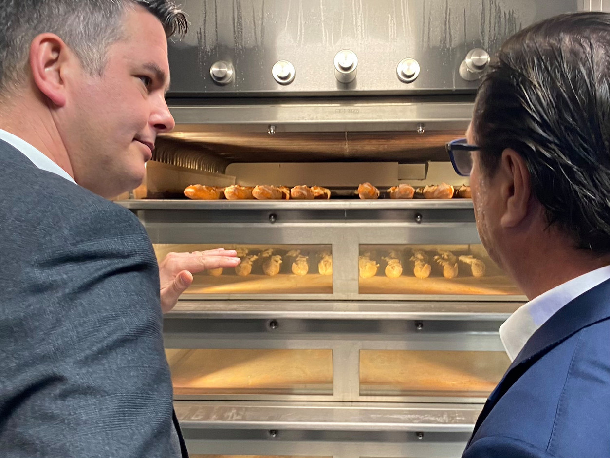Luxembourg’s economy minister Lex Delles (DP) being shown how the ovens work by the fifth generation of the Hein family, who heads the company. Photo: Maison Moderne