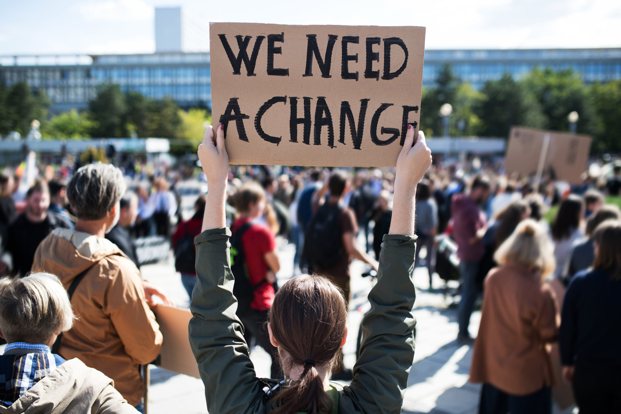 Rear view of people with placards and posters on global strike for climate change. Copyright (c) 2019 Halfpoint/Shutterstock.  No use without permission.