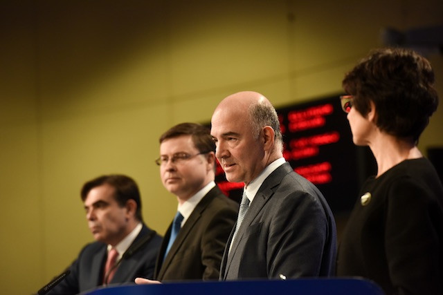 European commissioners are seen during a press conference in Brussels on 22 November 2017. Pictured are Valdis Dombrovskis, vice president of the European Commission in charge of the euro, social dialogue, financial stability, financial services and Capital Markets Union (second from left); Pierre Moscovici, the European commissioner in charge of economic and financial affairs, taxation and customs (second from right); and Marianne Thyssen, European employment commissioner (right). European Commission
