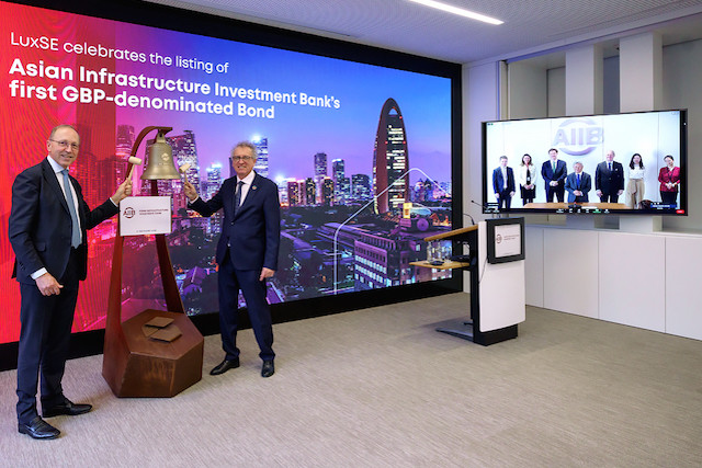 Finance Pierre Gramegna is pictured at the ringing the bell ceremony on Wednesday 21 October with AIIB president Jin Liquin, pictured onscreen, attending the event virtually from Beijing.  Luxembourg Stock Exchange