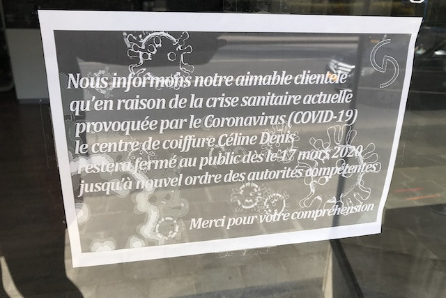 A sign posted in a hair salon explaining its closure as part of measures to curb the spread of coronavirus JB