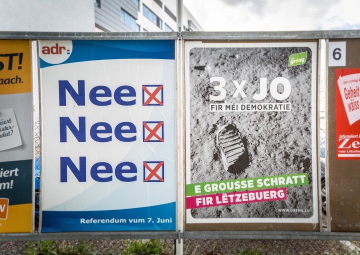 The national council of foreigners (CNE) has been in crisis; its newly elected members have proposed several reforms. Pictured: campaign posters for the June 2015 national referendum. Maison Moderne