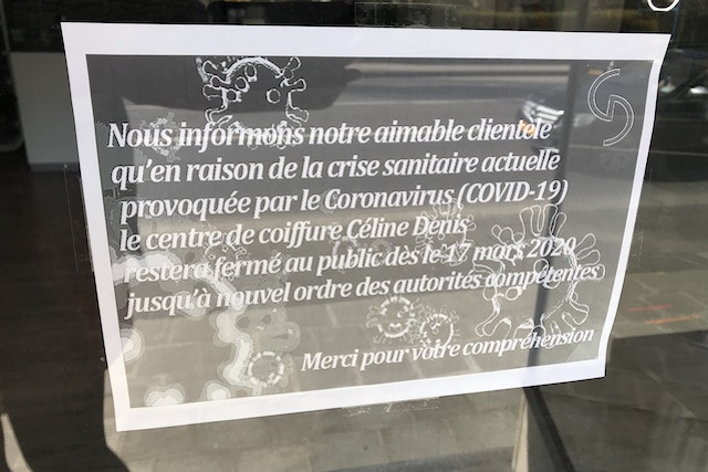 A sign posted in the window of a hair dressing salon explains it is closed to prevent the spread of coronavirus Jess Bauldry