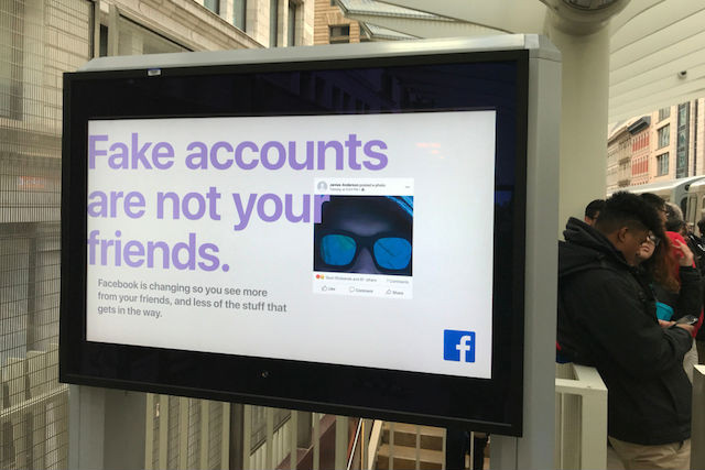 April 4 2018 photo of a train station in Chicago featuring a Facebook ad warning against fake accounts Shutterstock