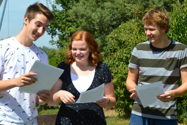 Students at St George's International School smile as they read their exam results St George's International School