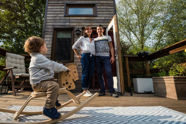 Emmy McNiece, Quentin Richard and Zachary stand in front of their tiny house Mike Zenari