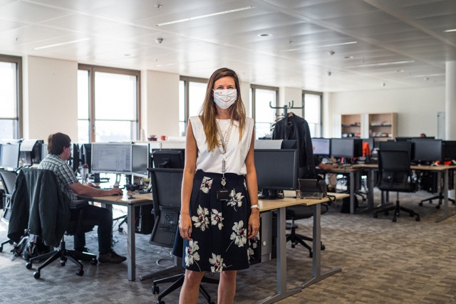 Florence Auquier, sporting a company-branded mask, in her open plan office space at ING’s Luxembourg headquarters on place de la Gare. Mike Zenari