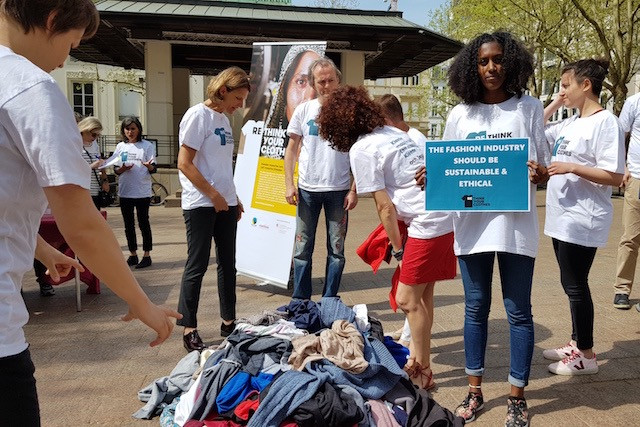 The artist Jennifer Lopes (holding poster) is seen during a rally, held as part of the “Rethink your clothes” campaign, on the place d’Armes, 24 April 2018. The initiative encourages consumers to contribute to the improvement of living and working conditions in the textile industry, and greatly reduce the ecological footprint of their wardrobes. Staff