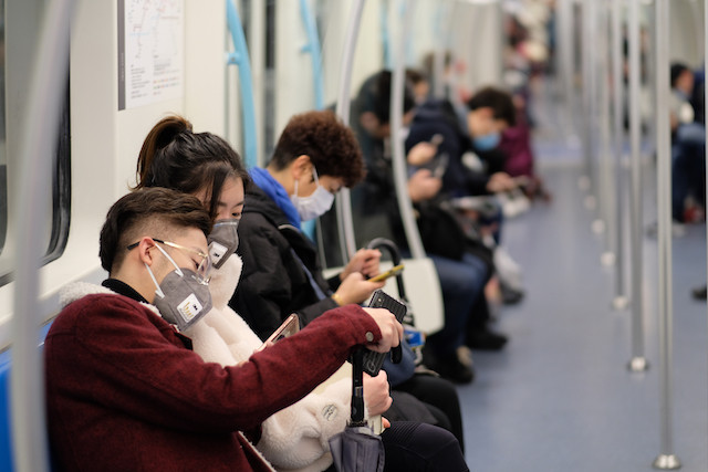 People wearing surgical mask sitting in subway in Shanghai in January 2020 Shutterstock