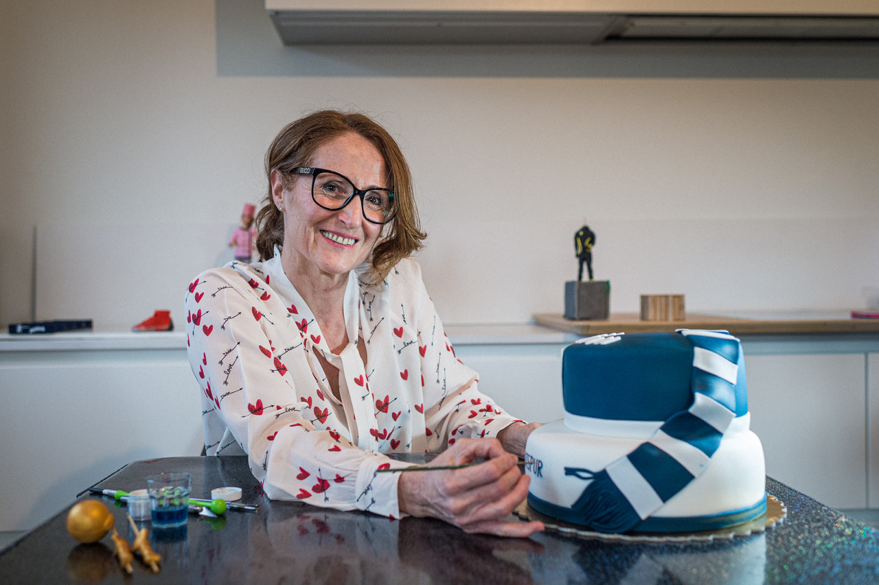 Licia Zappatore putting the finishing touches on a cake with a Tottenham Hotspur Football Club theme Mike Zenari