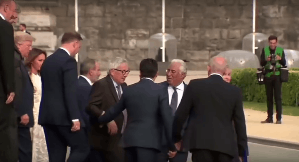 Jean-Claude Juncker is assisted by fellow Nato leaders as he stumbles after a photo shoot at the summit in Brussels YouTube screenshot