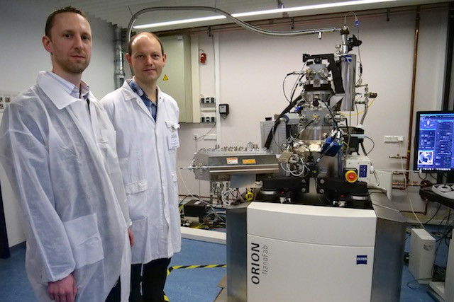 David Dowsett of LION Nano-Systems (on left) and Tom Wirtz of the  Luxembourg Institute of Science and Technology pose in front of the Zeiss Orion NanoFab kitted with the Vector500 SIMS tool. Luxembourg Institute of Science and Technology