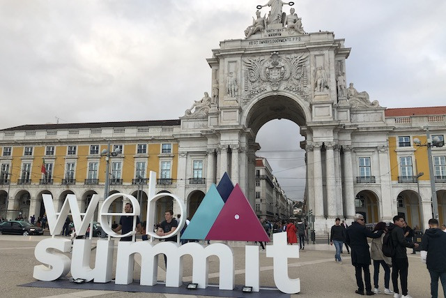 Energies are high in Lisbon as visitors snap photos with the Web Summit logo on the Praça do Comércio on Sunday evening Delano