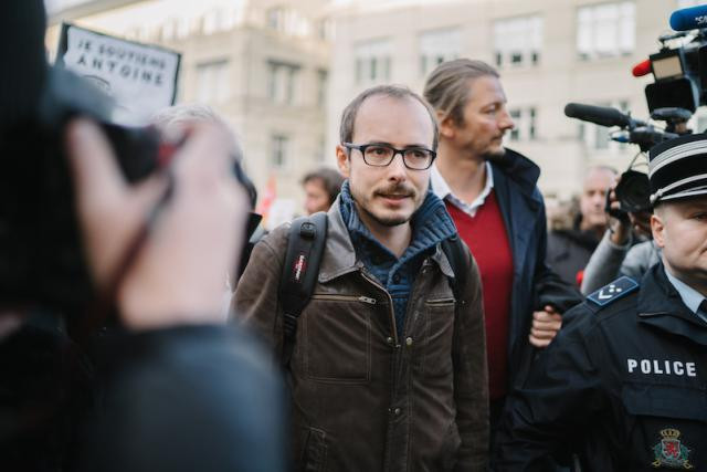 Antoine Deltour (centre) is seen entering the central courthouse complex in Luxembourg City before an appeals hearing in the LuxLeaks case on 12 December 2016 Marion Dessard