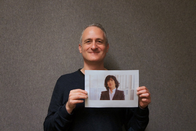 Aaron Grunwald, pictured, holds a photo of CNN journalist Christiane Amanpour Staff