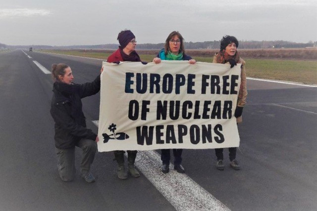 Tilly Metz (2nd right) alongside fellow protesters on the runway at the Kleine-Brogel military airbase on Wednesday morning Twitter/Molly Scott Cato