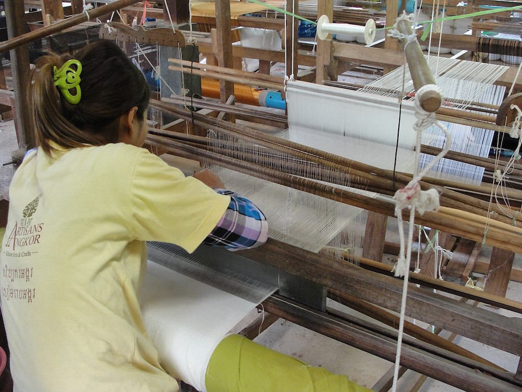 A silk worker in Cambodia. Sewbot machines could potentially do the work of 10 people in the garment industry. John and Carolina/Flickr
