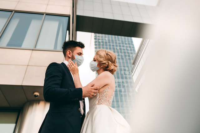 Illustration photo shows a bride and groom wearing masks. Social distancing regulations introduced since the pandemic mean fewer people can be accommodated in enclosed spaces, that includes for weddings Shutterstock