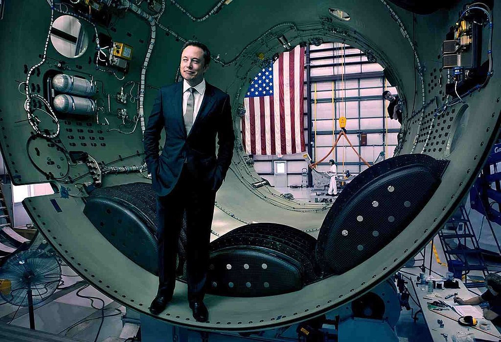 Elon Musk stands inside a rocket awaiting assembly SpaceX