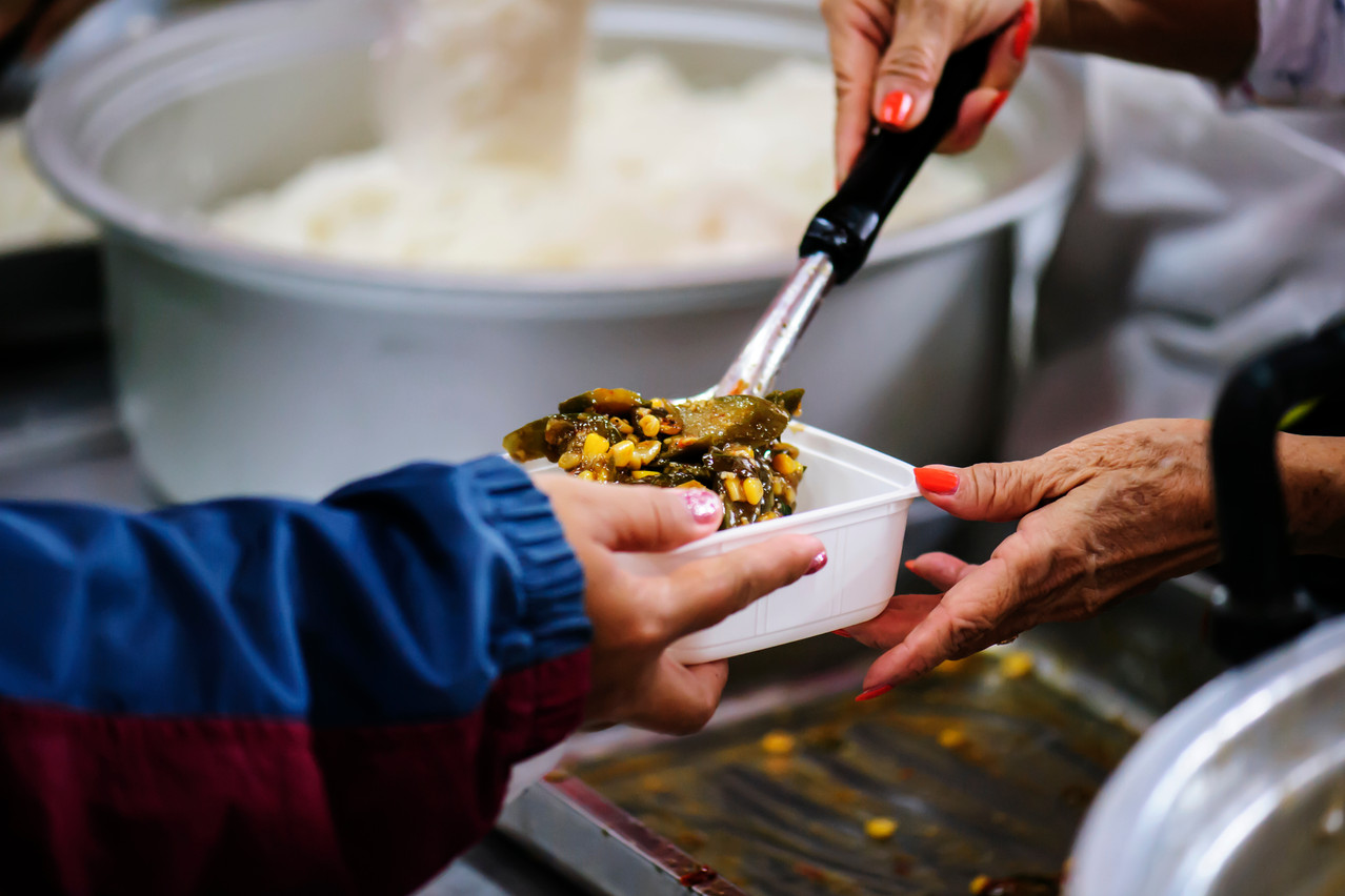 Volunteers are needed to distribute warm meals and help with other tasks, such as cleaning cutlery. Shutterstock