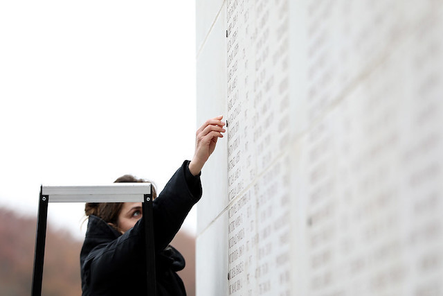 American Battle Monuments Commission superintendent Jennifer Roman placing a rosette on the Wall of the Missing at the cemetery in Hamm to signify Donald E. Mangan had returned home. The 26-year-old had been considered missing in action since 17 September 1944.  US Embassy Luxembourg