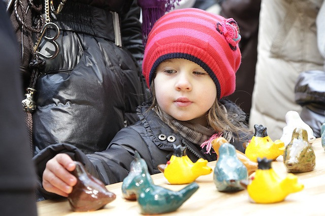 A child looks at Peckvillercher (clay bird whistles) during Emaischen (Easter Monday market) in Luxembourg City, in 2013 Luc Deflorenne