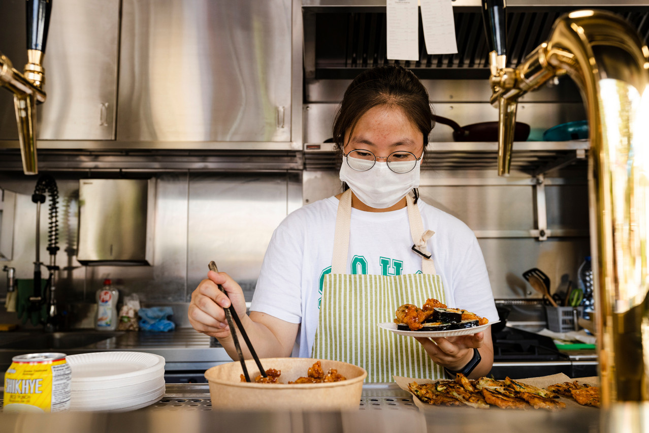 Unsill Kim’s daughter helps prepare the meals served at the pop-up kitchen.  Photo: Photo: Caroline Martin