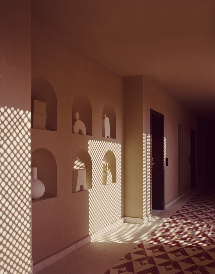 For the corridor at the  Three Corners Ocean View Hotel , the new design introduced layered wooden screens, a familiar Egyptian vocabulary-simple, porous, regulating light as much as view.   Simon Menges & Nino Tugushi