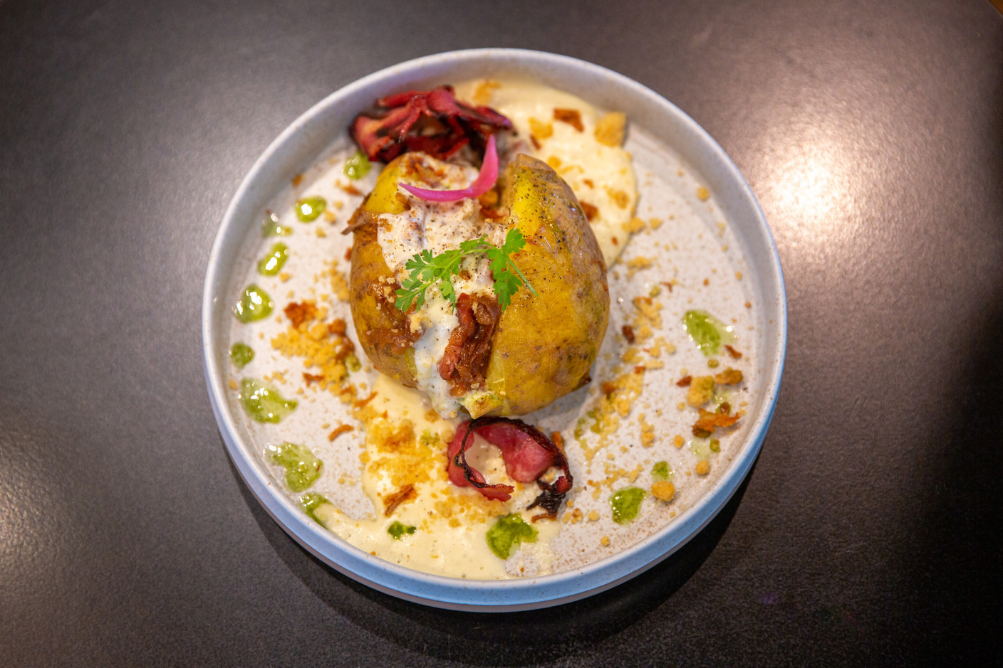 A Savoyard version of the potato with a siphon of Reblochon cheese, caramelised onions and crispy ham. (Photo: Romain Gamba/Maison Moderne)
