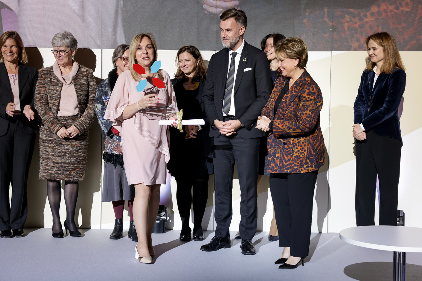 Day 2: Banco FIE represented by its President, Ximena Behoteguy, receiving the award from Her Royal Highness the Grand Duchess and President of the High Jury with members of the selection committee on stage    InFiNe.lu