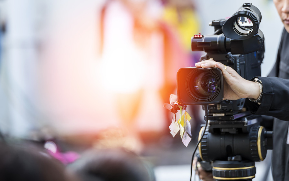Video camera operator working with his equipment Shutterstock