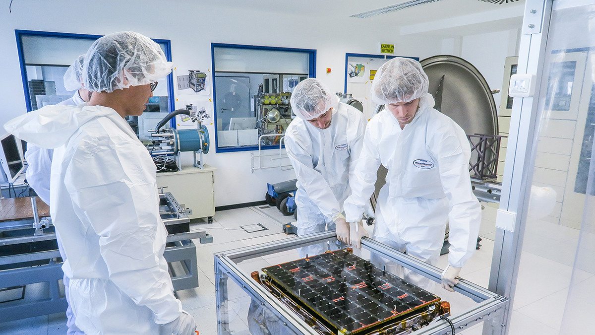ICEYE specialists inspecting one of the company’s SAR satellites in a clean room. Photo: ICEYE