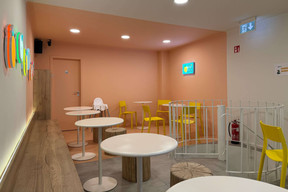 Upstairs, there are neon lights in the shape of fruit and wood and metal furniture. Photo: Guo Cha Club