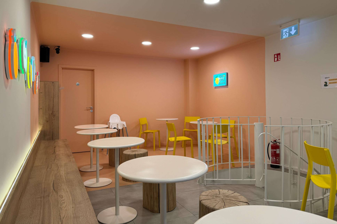 Upstairs, there are neon lights in the shape of fruit and wood and metal furniture. Photo: Guo Cha Club