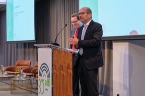 Jonathan Lipkin of the Investment Association and Jean-Marc Goy of the Association of the Luxembourg Fund Industry, seen speaking at Alfi’s London conference, 19 October 2023. Photo: ALFI