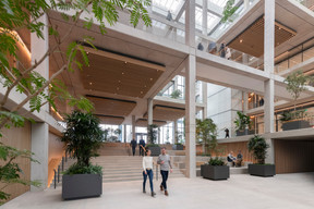 On the ground floor of the atrium, the staircases absorb the difference in level between the Place de France and the Place de l’Académie. Nigel Young/Foster + Partners