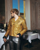 Atelier Persona leather jacket, skintight pants. He walks in like the party is waiting for him. Photo: Julian Pierrot/Paperjam