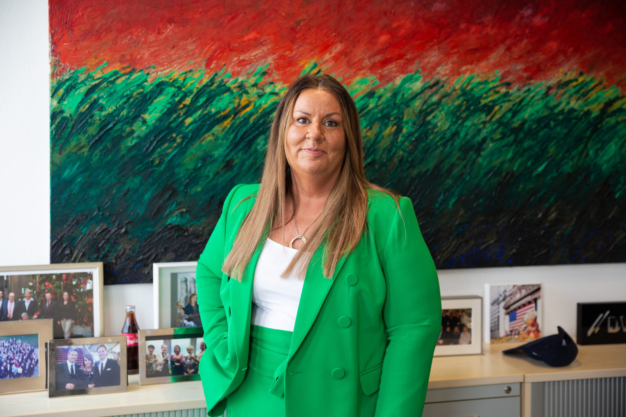 Nathalie Bausch, CEO and head of HR EMEA at DWS Investment in Luxembourg, is seen standing in front of a Fernand Roda painting in her office during an interview with Delano, 4 May 2022. Photo: Romain Gamba