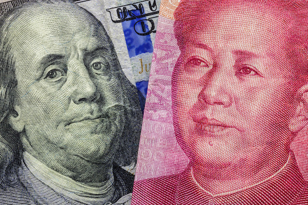 Close up of one hundred Dollar and 100 Yaun banknotes with focus on portraits of Benjamin Franklin and Mao Tse-tung / USA vs China trade war concept. Photo: Lyxor ETF